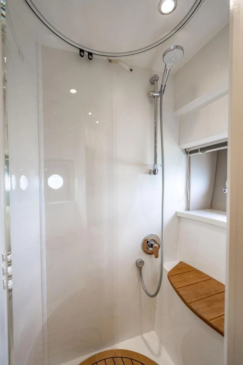 Slide: The Image of Luxurious shower in 2012 Princess V45 yacht with modern fixtures and wooden accents. - 34