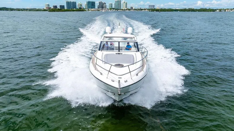 Slide: The Image of Princess V45 yacht cruising on open water, city skyline in background, 2012 model. - 6