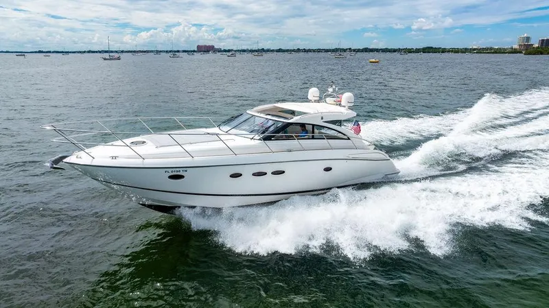 Slide: The Image of 2012 Princess V45 yacht cruising on open water under a clear sky. - 7