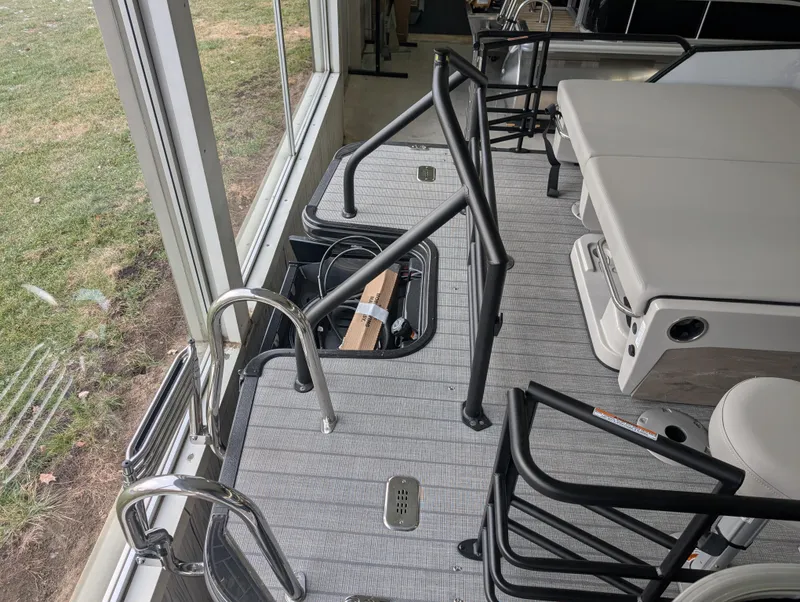 Slide: The Image of 2025 Sylvan L3 DLZ Bar pontoon boat interior with seating and railing. - 13