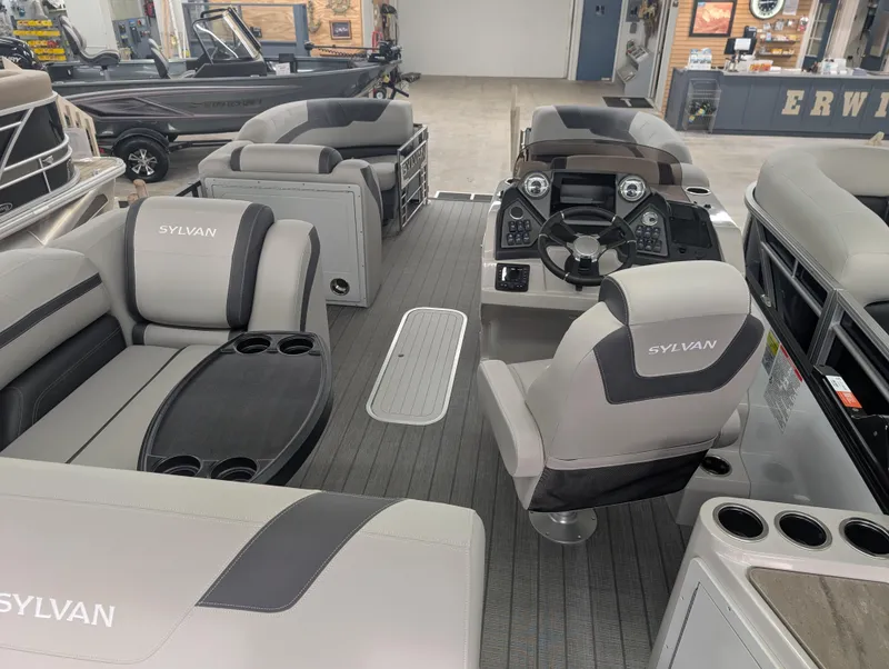 Slide: The Image of 2025 Sylvan L3 DLZ Bar pontoon boat interior with luxurious seating and modern dashboard. - 16