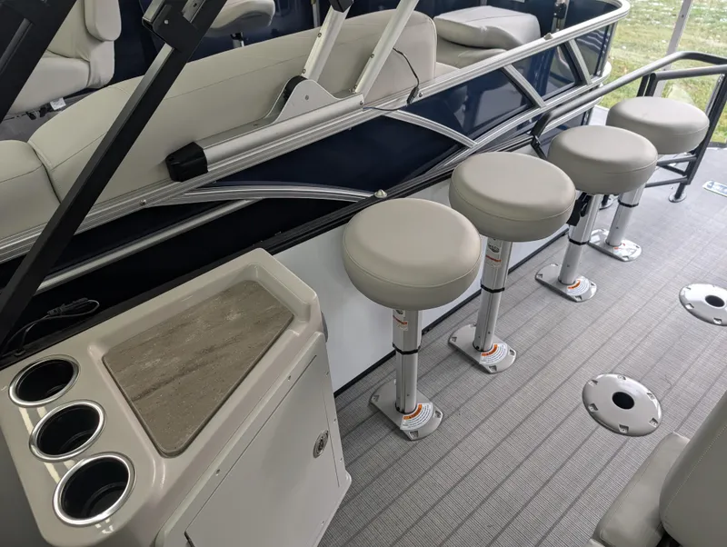 Slide: The Image of 2025 Sylvan L3 DLZ Bar interior with bar stools and cup holders. - 8