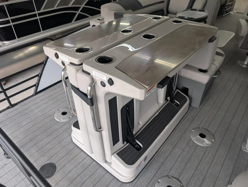 Slide: The Image of 2025 Sylvan L3 DLZ Bar pontoon boat with sleek bar seating and cup holders. - 9