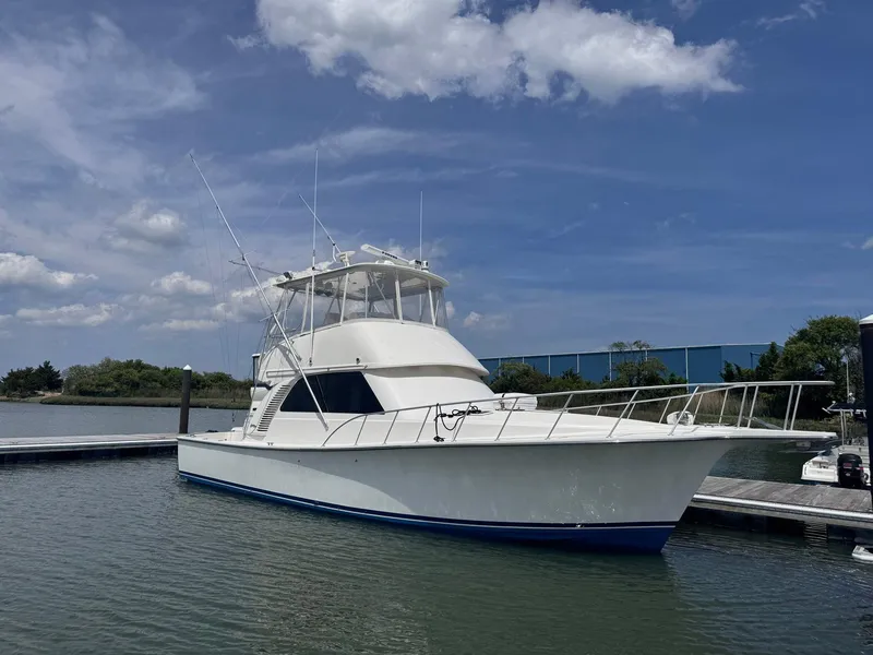 Slide: The Image of 2011 Henriques 42 Sportfisherman boat docked under a blue sky. - 1