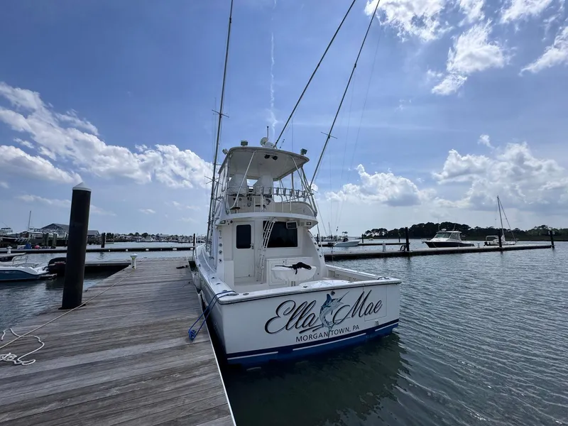 Slide: The Image of 2011 Henriques 42 Sportfisherman docked at marina under blue sky. - 2