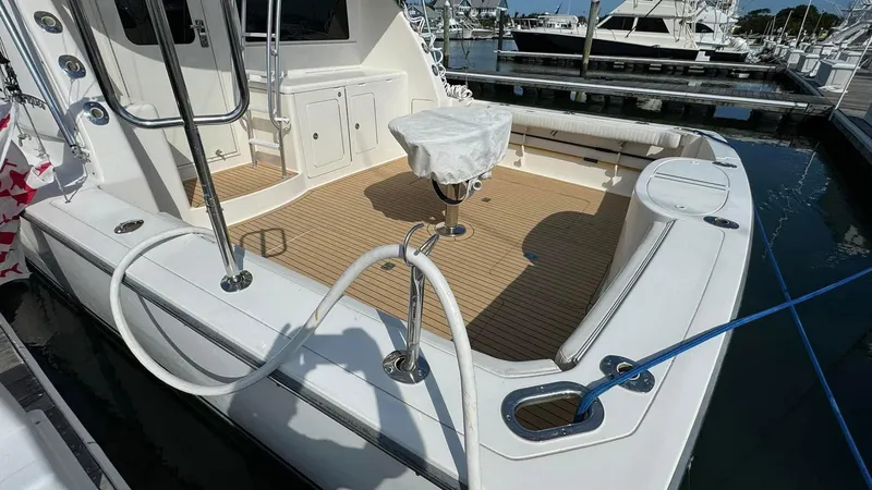 Slide: The Image of 2011 Henriques 42 Sportfisherman boat deck with covered seating and fishing equipment. - 3