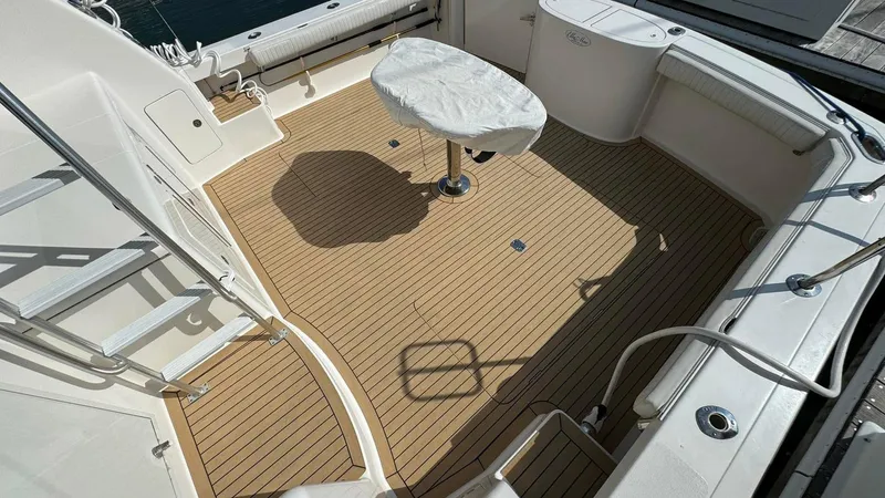 Slide: The Image of Henriques 42 Sportfisherman 2011 boat deck with covered table and seating area. - 4