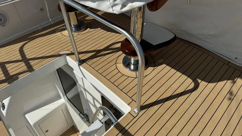 Slide: The Image of Henriques 42 Sportfisherman 2011 boat deck with wooden flooring and metal railings. - 5