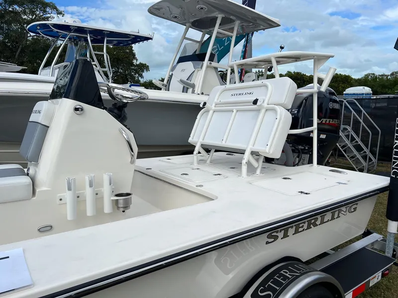 Slide: The Image of 2023 Sterling 180TS boat with white deck and seating, displayed outdoors. - 5