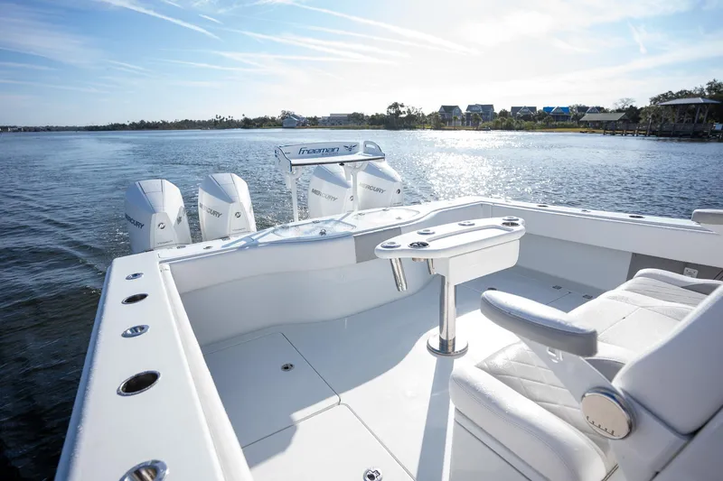 Slide: The Image of 2023 Freeman 42 LR boat on water, featuring spacious deck and powerful engines. - 19