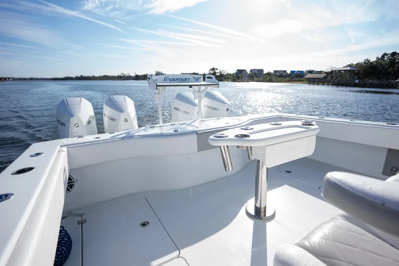 Slide: The Image of 2023 Freeman 42 LR boat on water, featuring spacious deck and powerful engines. - 22