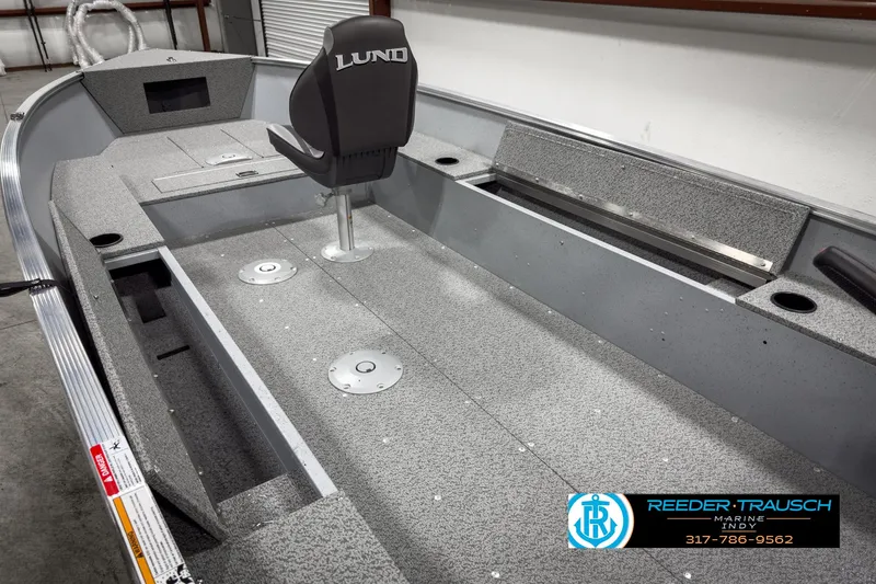 Slide: The Image of 2025 Lund 1600 Fury Heritage Edition boat interior with seating and storage compartments. - 14