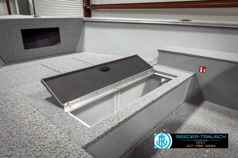 Slide: The Image of 2025 Lund 1600 Fury Heritage Edition boat interior with storage compartment open. - 16