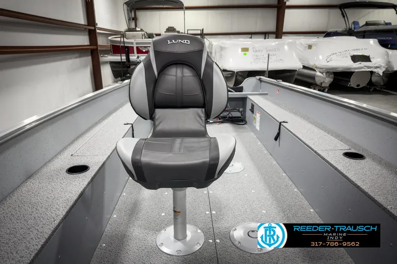 Slide: The Image of 2025 Lund 1600 Fury Heritage Edition boat interior with a central seat in a showroom. - 17