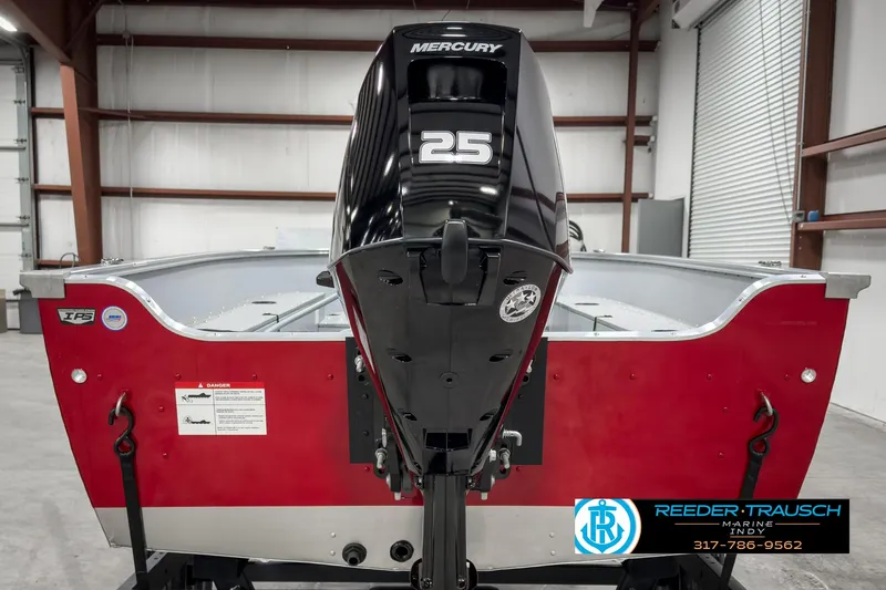 Slide: The Image of 2025 Lund 1600 Fury Heritage Edition boat with Mercury 25 engine in a warehouse. - 5