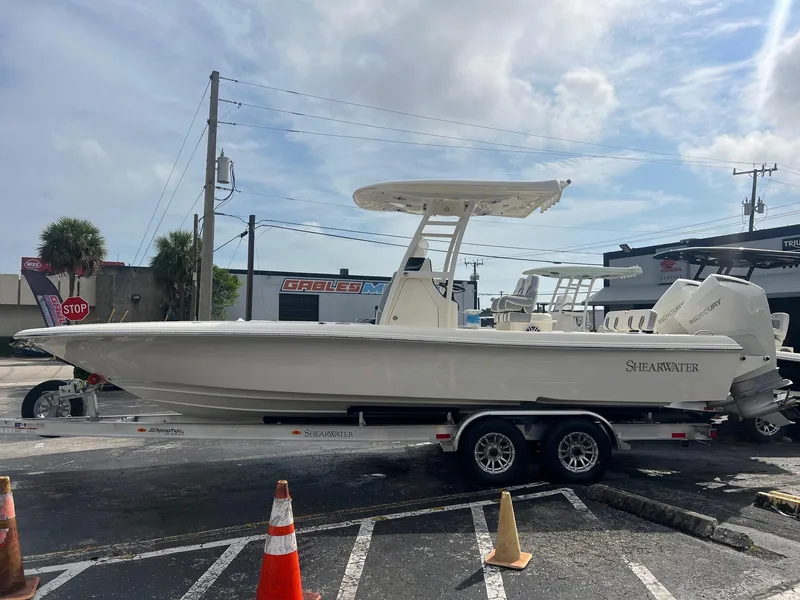 The Image of 2024 ShearWater 270 SS Open Carolina boat on trailer in parking lot. - 1