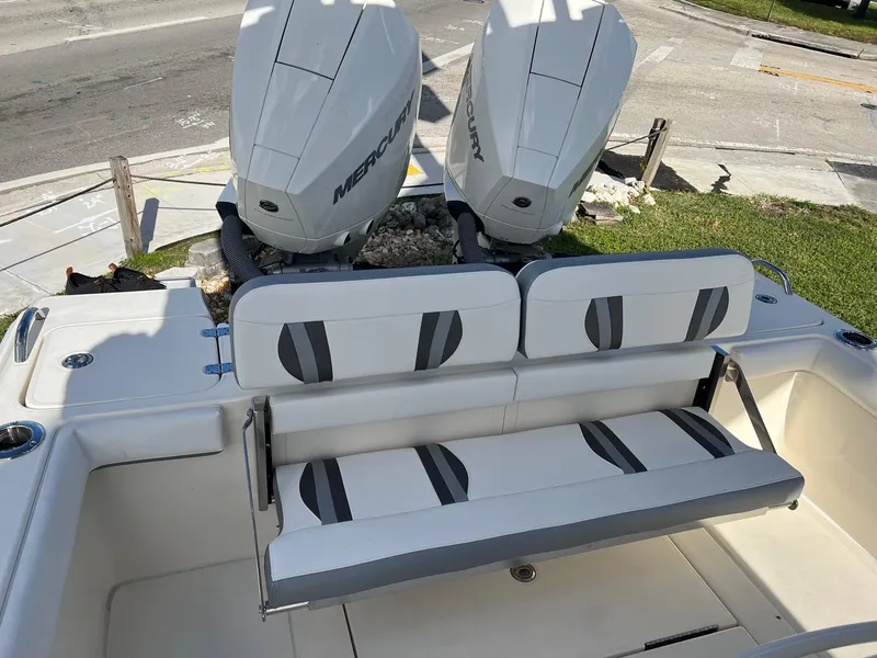 Slide: The Image of 2024 ShearWater 270 SS Open Carolina boat with dual Mercury engines and cushioned seating. - 11