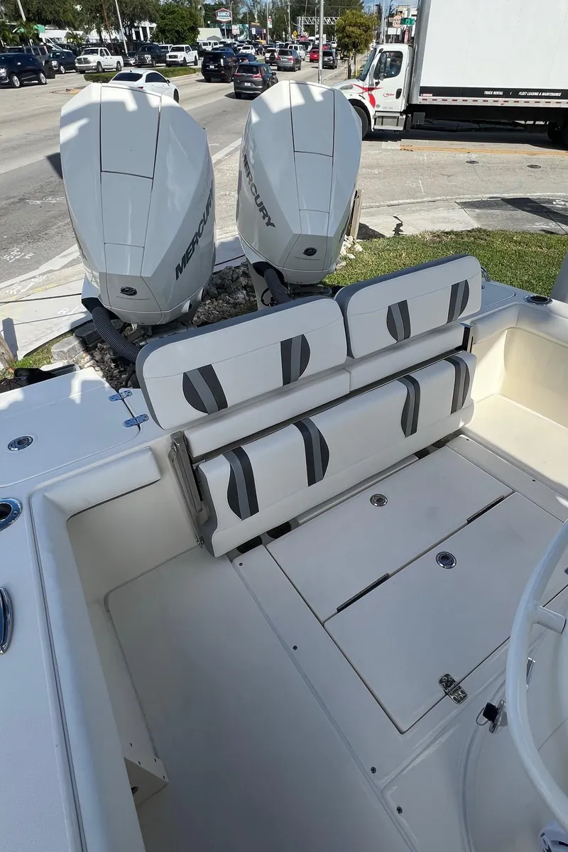 Slide: The Image of 2024 ShearWater 270 SS Open Carolina boat with dual Mercury engines, docked in a marina. - 12