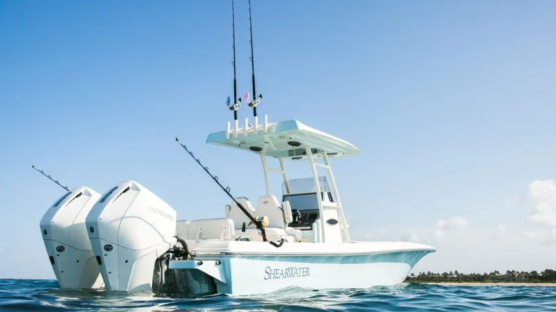 Slide: The Image of 2024 ShearWater 270 SS Open Carolina boat on water with fishing rods. - 15