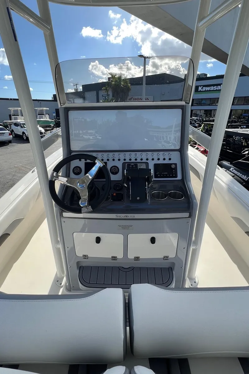 Slide: The Image of 2024 ShearWater 270 SS Open Carolina boat console with steering wheel and controls. - 4