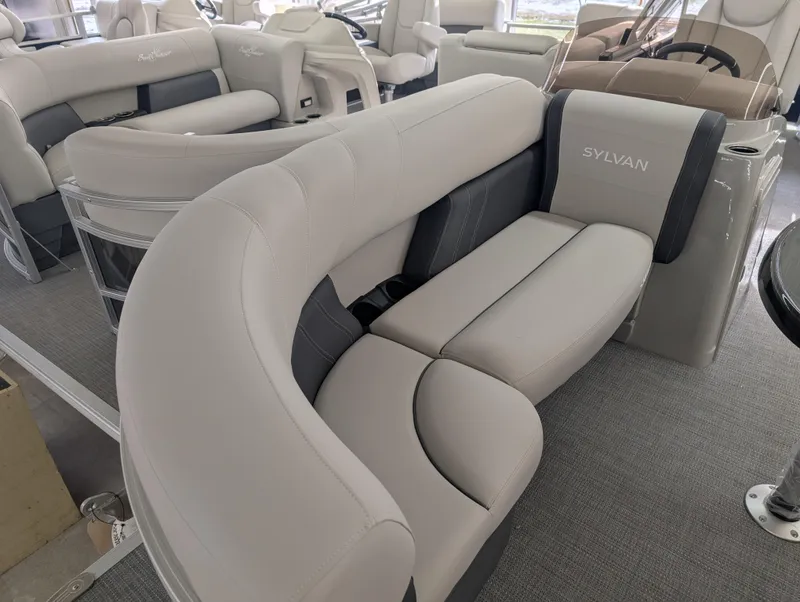 Slide: The Image of 2025 Sylvan Mirage Fish 8520 Party Fish boat interior with plush seating. - 3