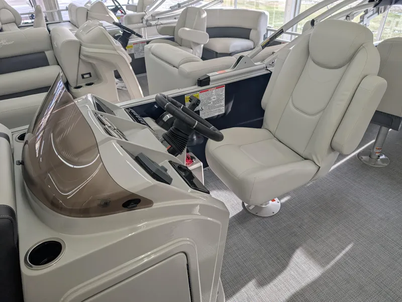 Slide: The Image of 2025 Sylvan Mirage Fish 8520 Party Fish boat interior with captain's chair and console. - 5