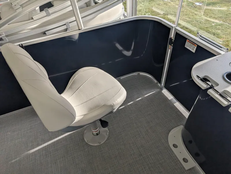 Slide: The Image of 2025 Sylvan Mirage Fish 8520 Party Fish boat interior with swivel chair and table. - 8