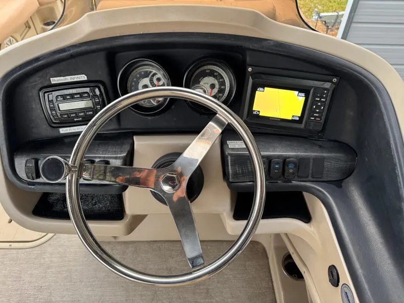 Slide: The Image of 2017 Avalon Catalina boat dashboard with steering wheel, gauges, and navigation system. - 12