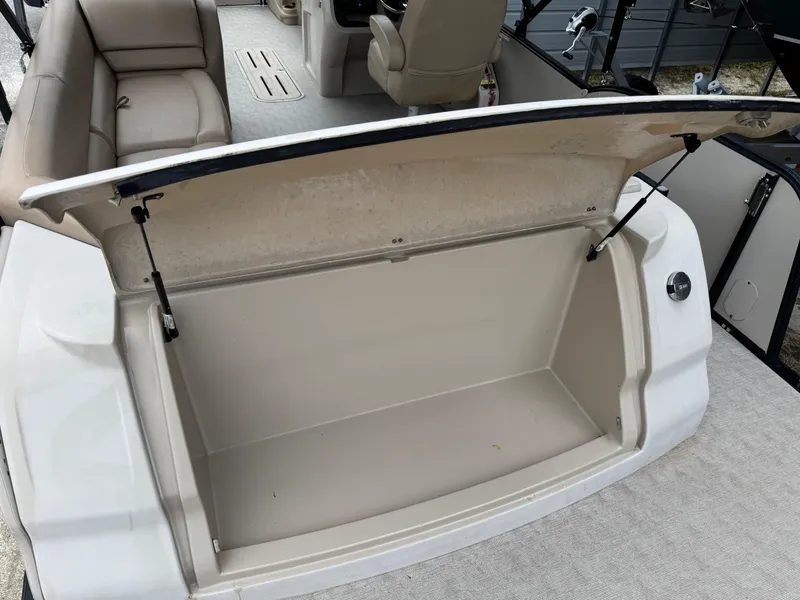 Slide: The Image of 2017 Avalon Catalina Rear J Lounger boat storage compartment open, showcasing spacious interior. - 16