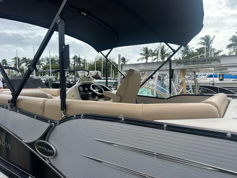 Slide: The Image of 2017 Avalon Catalina Rear J Lounger boat with canopy, docked at marina. - 3
