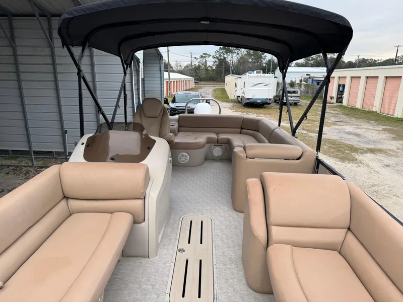 Slide: The Image of 2017 Avalon Catalina Rear J Lounger pontoon boat with tan seating and canopy. - 9