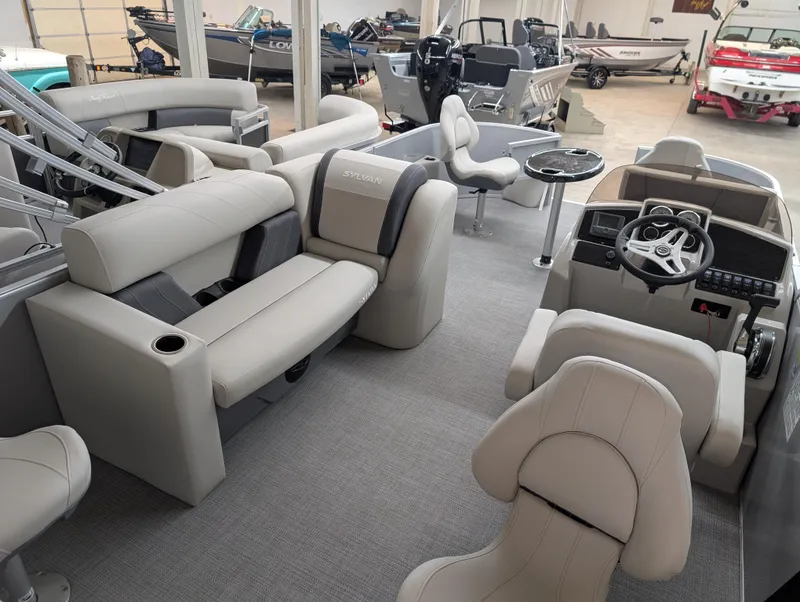 Slide: The Image of 2025 Sylvan Mirage Fish 820 Party Fish 4.0 interior with plush seating and modern helm. - 8