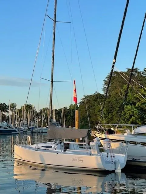 Slide: The Image of 2021 J Boats J 88 sailboat docked in a serene marina setting. - 1