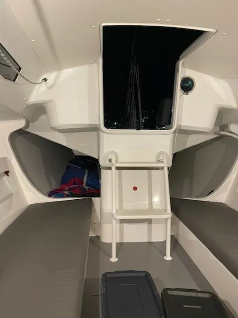 Slide: The Image of Interior of 2021 J Boats J 88 sailboat, featuring seating and storage. - 10