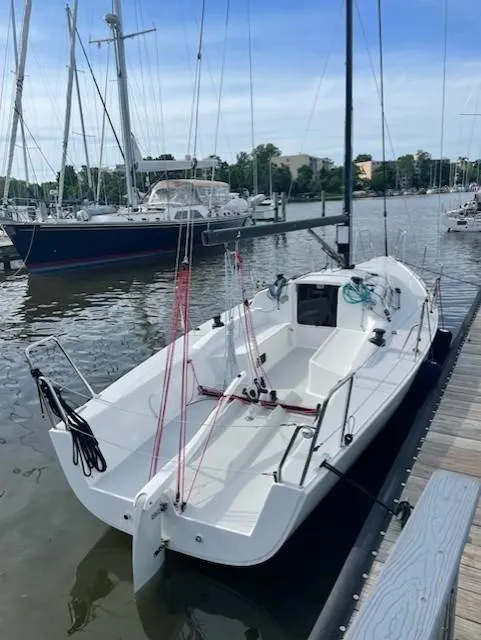 Slide: The Image of 2021 J Boats J 88 sailboat docked in a marina, ready for sailing. - 2