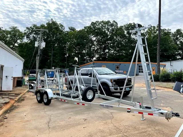 Slide: The Image of Trailer for 2021 J Boats J 88 sailboat, parked outdoors near industrial buildings. - 5