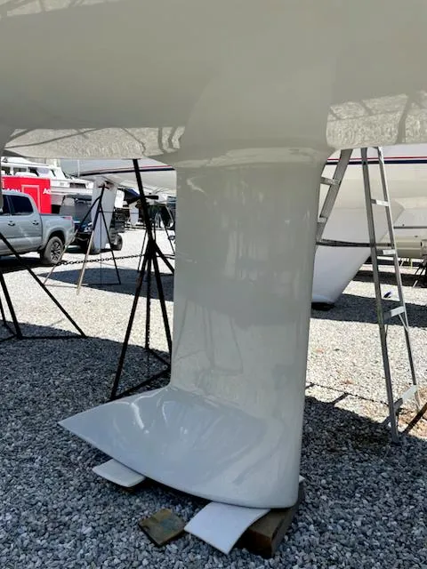 Slide: The Image of 2021 J Boats J 88 keel on gravel, with boats and equipment in background. - 7