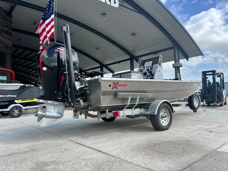 Slide: The Image of 2022 Hanko 185 CCLS boat on trailer, parked under a canopy with American flag. - 13