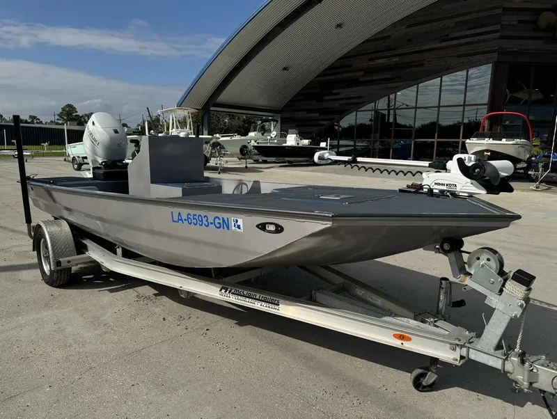 Slide: The Image of Custom Cottonmouth 1860 boat on trailer, 2022 model, parked outdoors. - 10