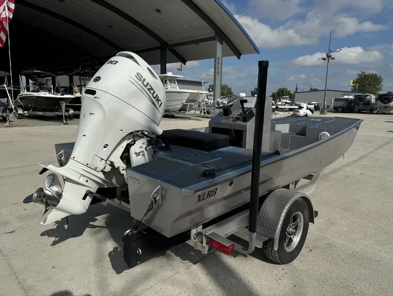 Slide: The Image of Custom Cottonmouth 1860 boat with Suzuki engine, parked on trailer, 2022 model. - 11