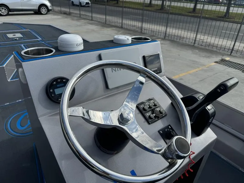 Slide: The Image of Steering console of 2022 Custom Cottonmouth 1860 boat with Garmin navigation. - 13