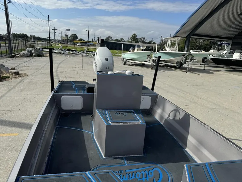 Slide: The Image of Custom Cottonmouth 1860 boat, 2022 model, parked outdoors with other boats nearby. - 16