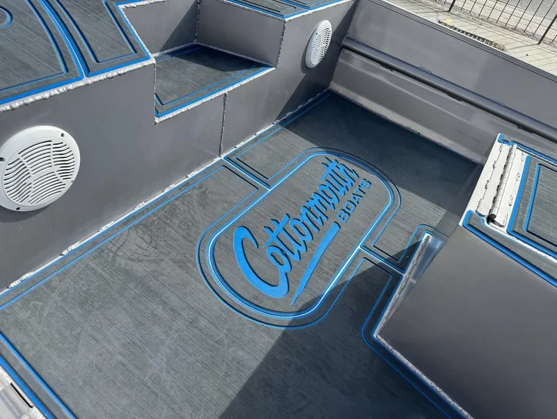 Slide: The Image of Custom Cottonmouth 1860 boat interior with logo, 2022 model, featuring speakers and blue accents. - 18