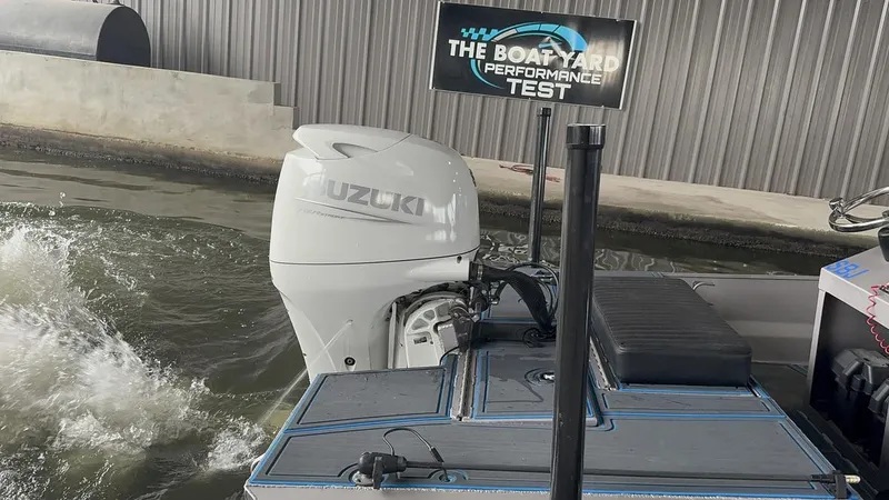 Slide: The Image of Custom Cottonmouth 1860 boat undergoing performance test with Suzuki outboard motor. - 19