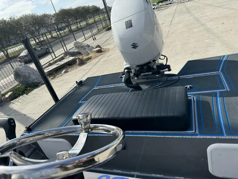 Slide: The Image of Custom Cottonmouth 1860 boat, 2022 model, with Suzuki outboard motor and steering wheel. - 6