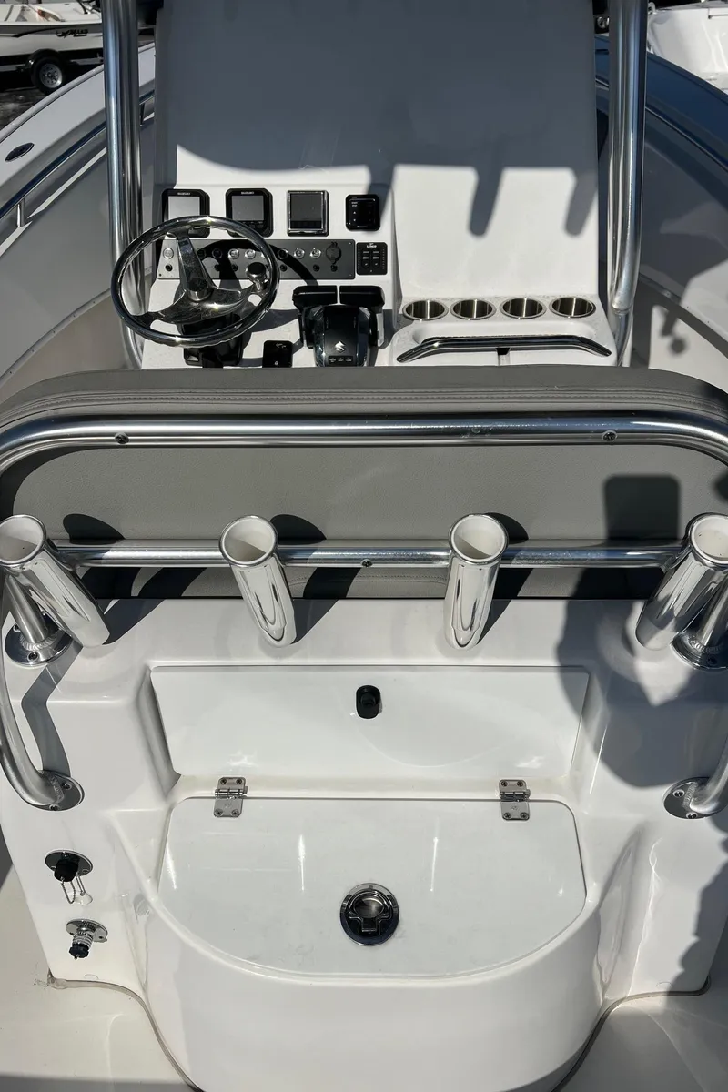 Slide: The Image of 2024 Cape Horn 24XS boat console with steering wheel and rod holders. - 4