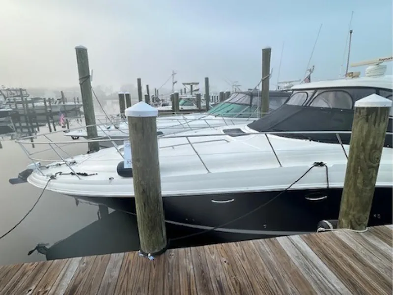 Slide: The Image of 2005 Sea Ray 390 Sundancer docked at a marina on a foggy day. - 1