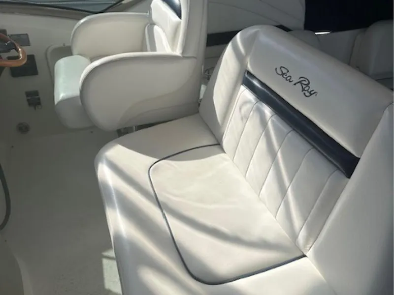 Slide: The Image of 2005 Sea Ray 390 Sundancer interior seating with white upholstery. - 3