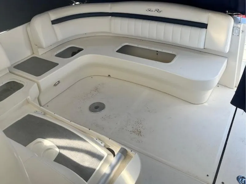 Slide: The Image of 2005 Sea Ray 390 Sundancer boat interior with white seating and storage compartments. - 5