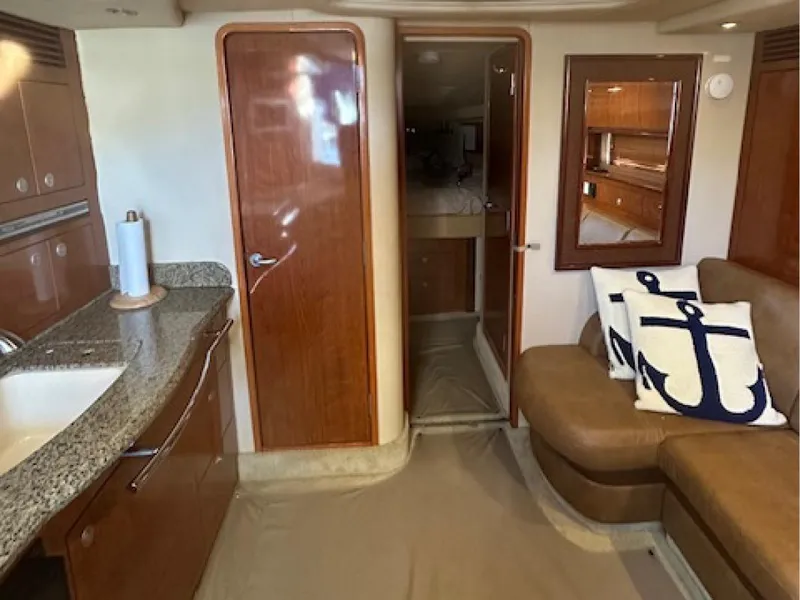 Slide: The Image of Interior of 2005 Sea Ray 390 Sundancer yacht with modern kitchen and seating area. - 6